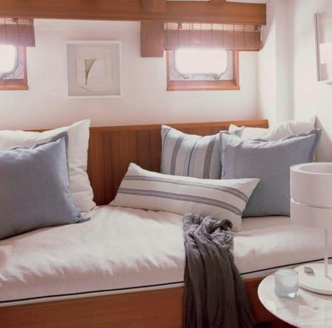 a couch with pillows aboard DAKOTA Yacht for Sale