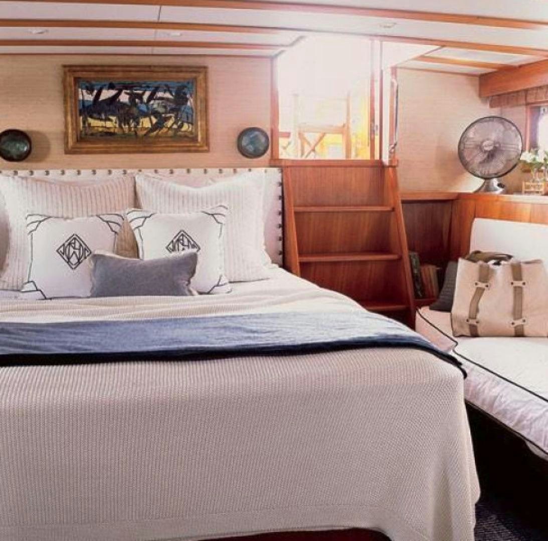 a bed with blue sheets aboard DAKOTA Yacht for Sale