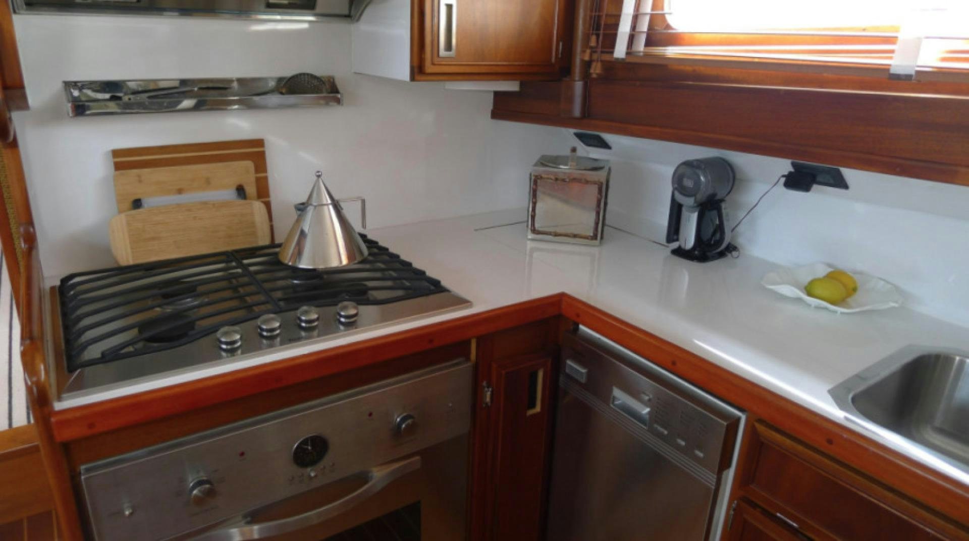 a kitchen with a tea kettle on the stove aboard DAKOTA Yacht for Sale