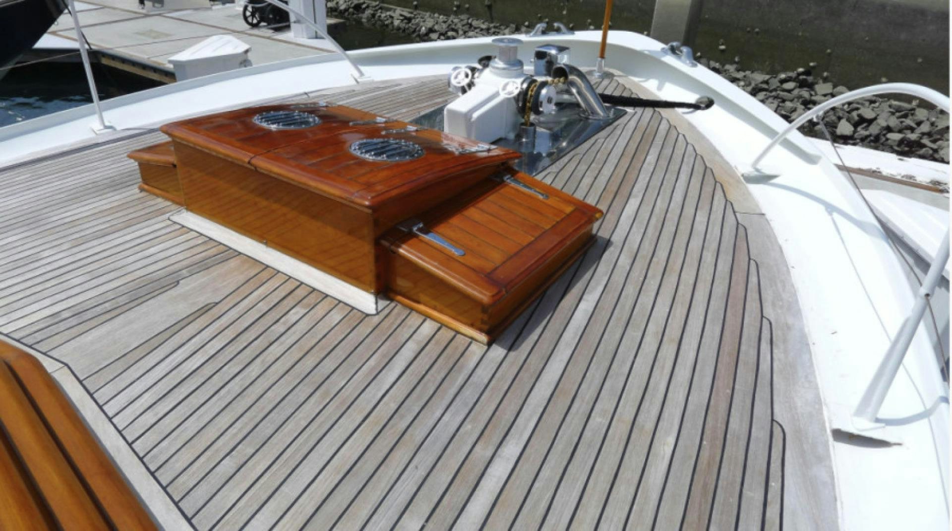 a wooden boat on a deck aboard DAKOTA Yacht for Sale