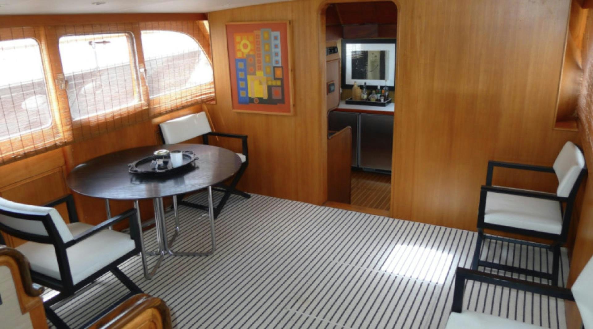 a room with a table chairs and a window aboard DAKOTA Yacht for Sale