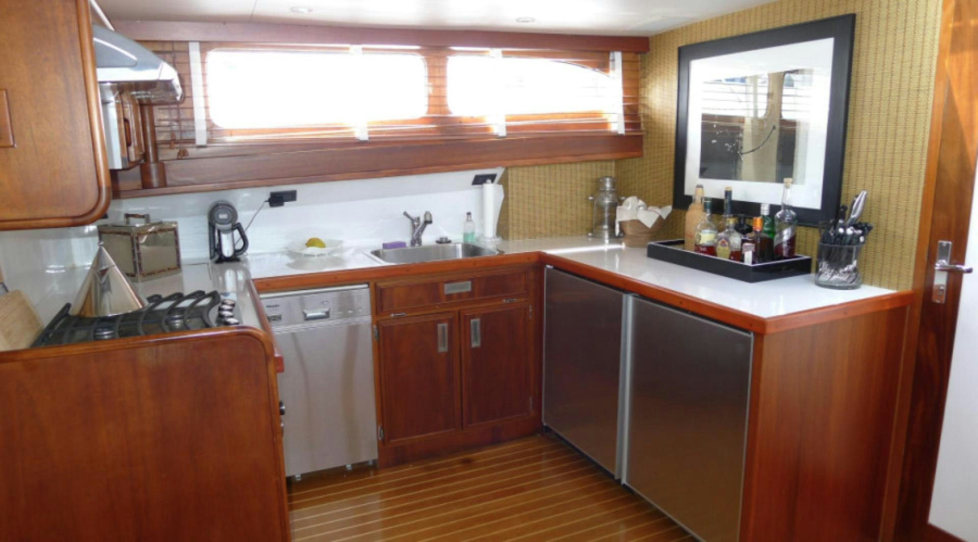a kitchen with wooden cabinets aboard DAKOTA Yacht for Sale