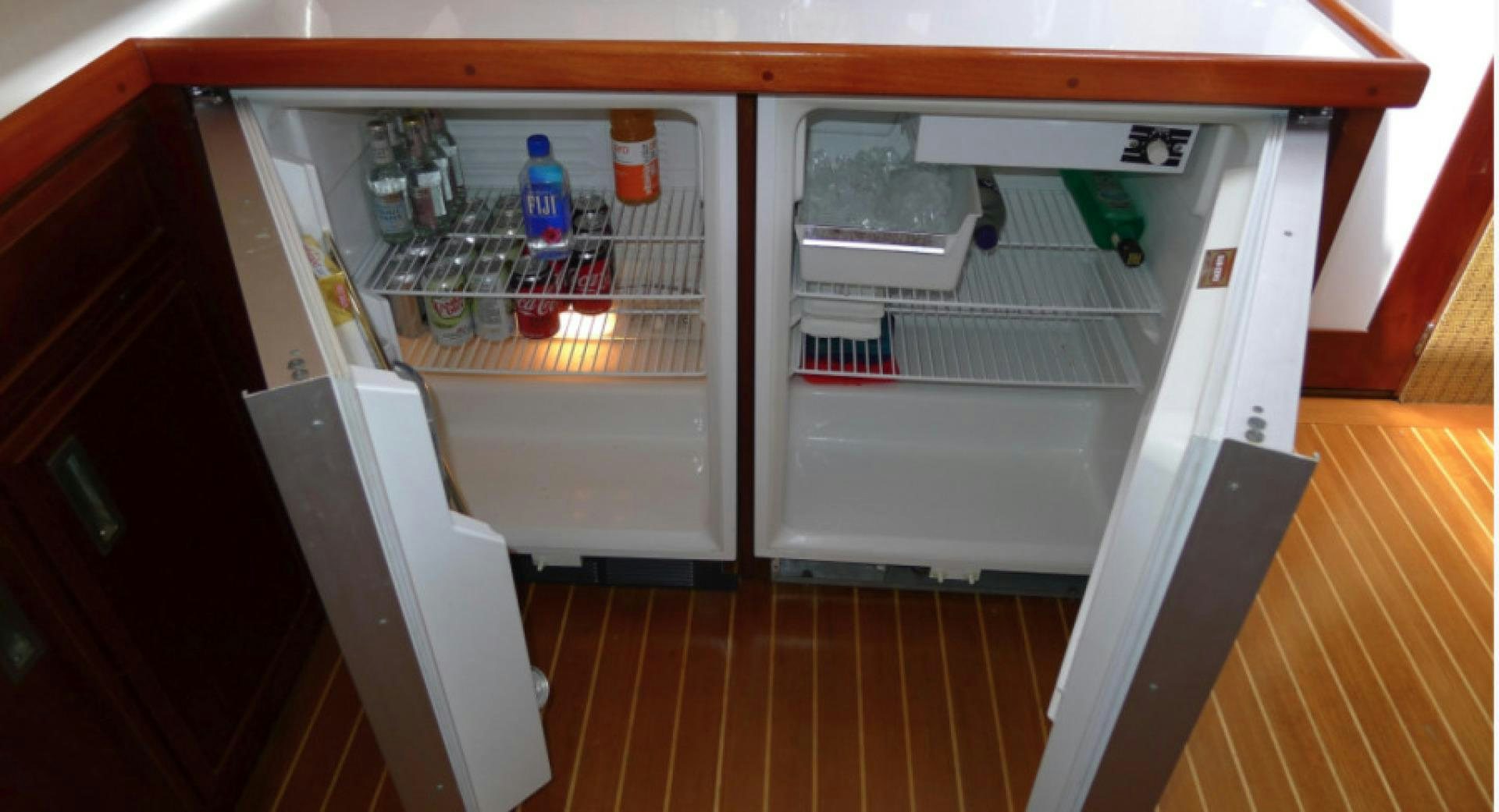 a refrigerator with a door open aboard DAKOTA Yacht for Sale