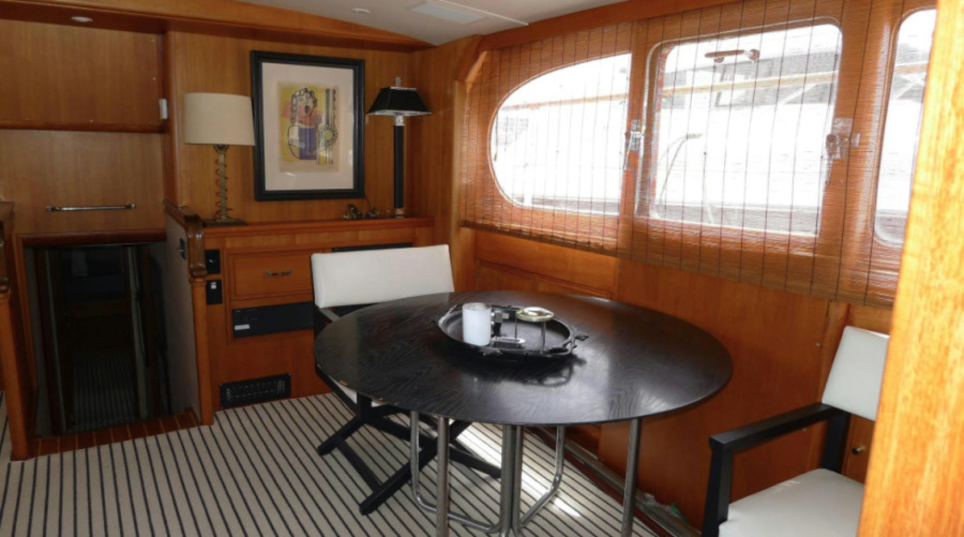 a room with a table and chairs aboard DAKOTA Yacht for Sale