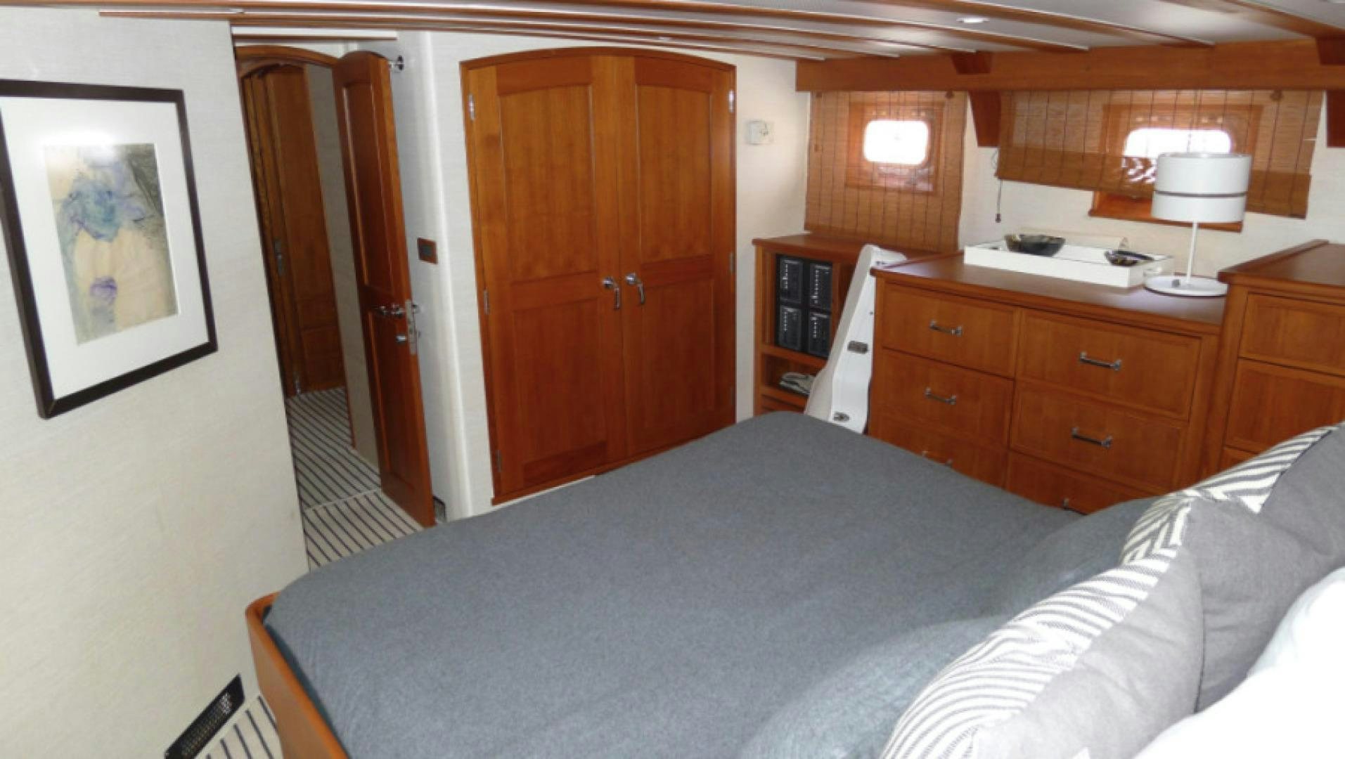 a bedroom with a bed and a desk aboard DAKOTA Yacht for Sale