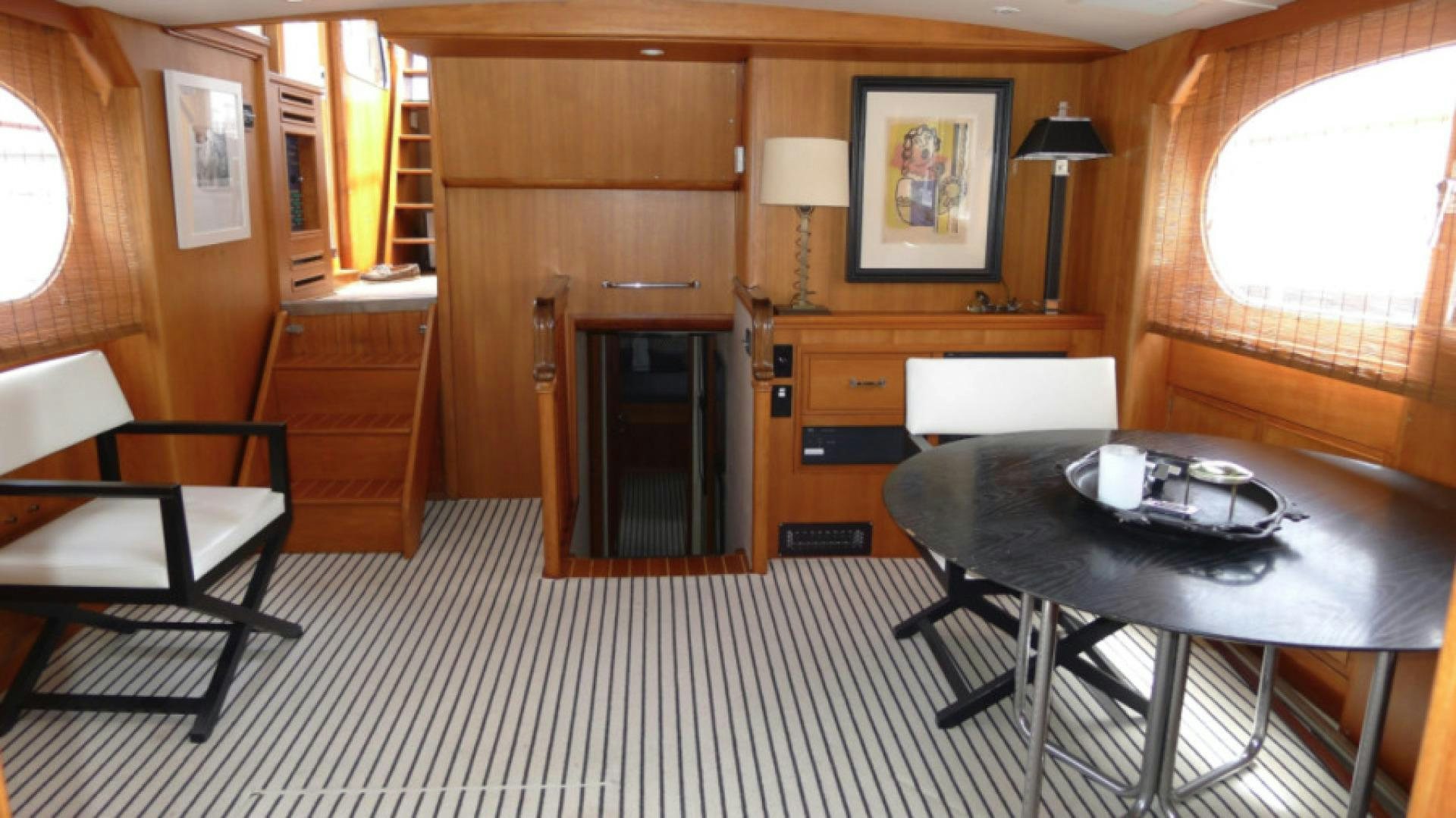 a room with a table and chairs aboard DAKOTA Yacht for Sale