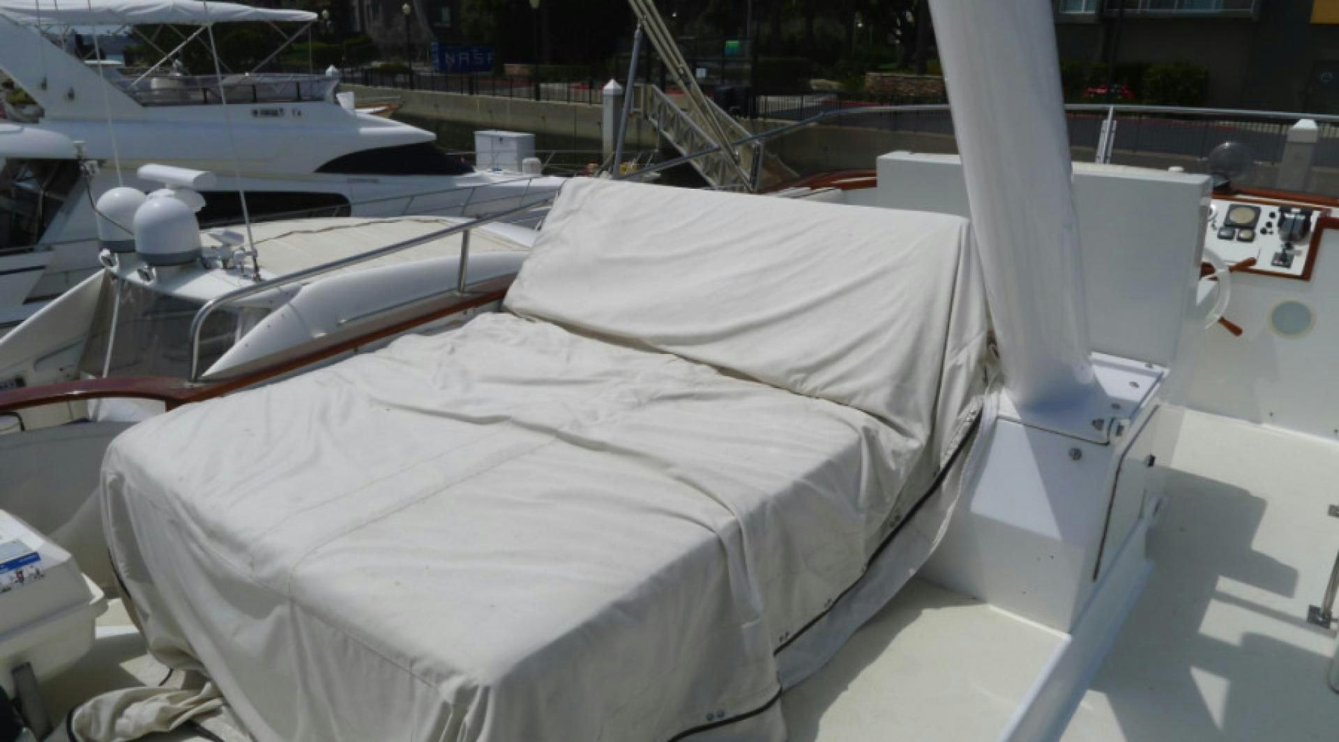 a white bed on a boat aboard DAKOTA Yacht for Sale