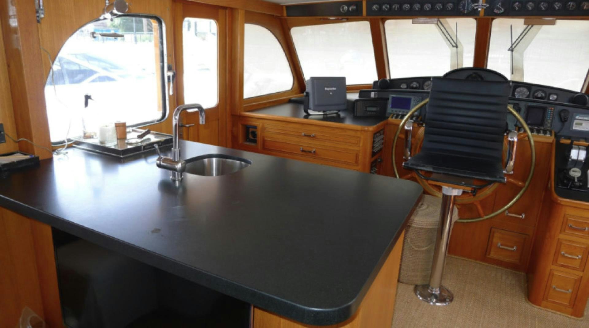 a computer on a desk aboard DAKOTA Yacht for Sale