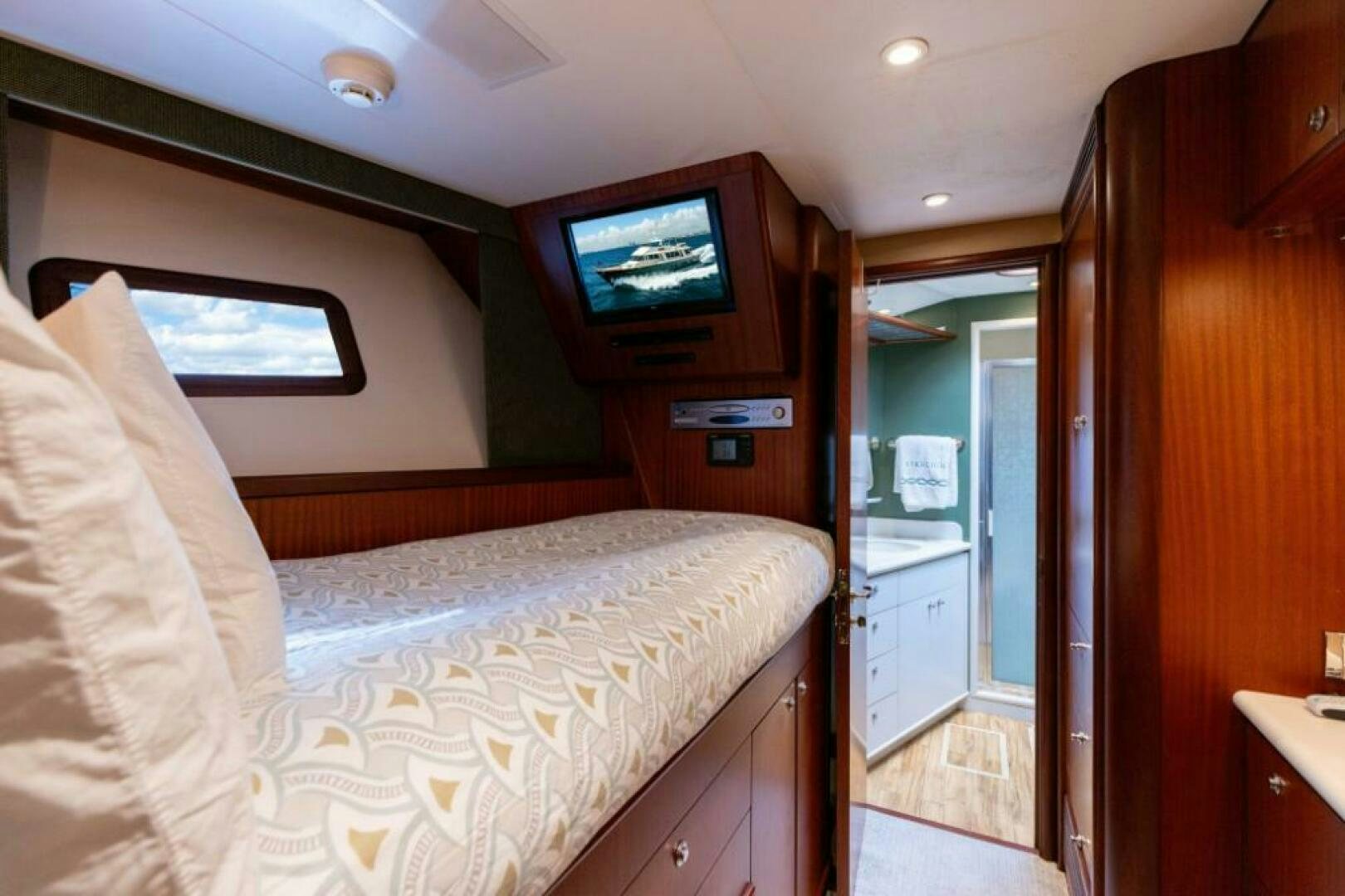 a bedroom with a bed and tv aboard STARLIGHT Yacht for Sale