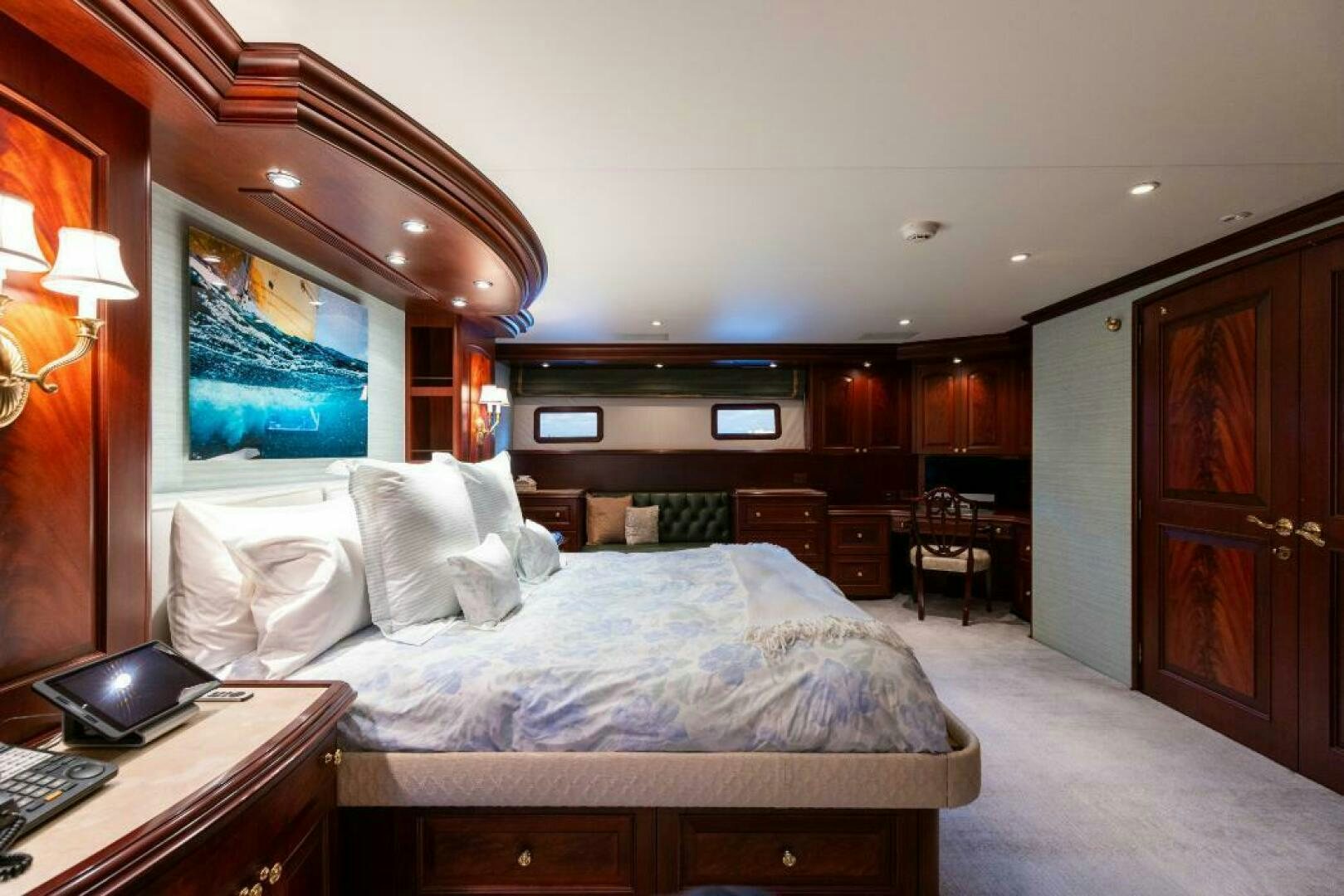 a bedroom with a bed and a desk aboard STARLIGHT Yacht for Sale