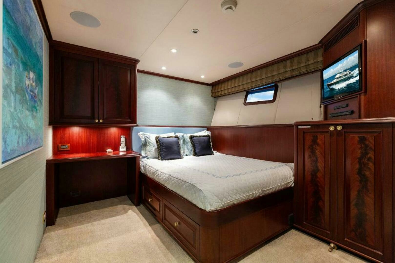 a bedroom with a bed and a television aboard STARLIGHT Yacht for Sale