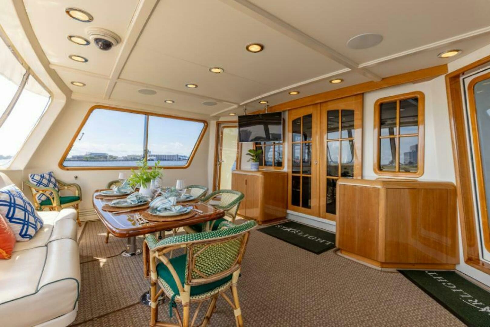 a living room with a table and chairs aboard STARLIGHT Yacht for Sale