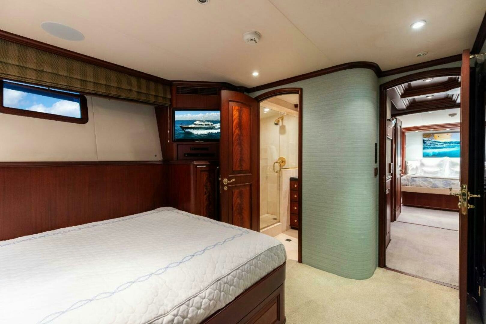 a bedroom with a tv on the wall aboard STARLIGHT Yacht for Sale