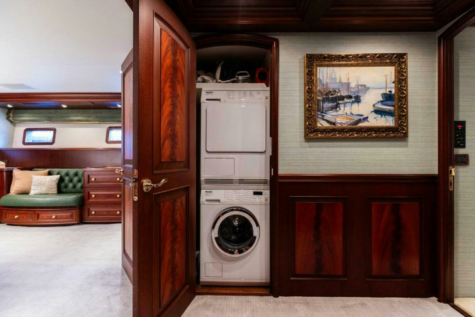 a room with a washing machine and a bed aboard STARLIGHT Yacht for Sale