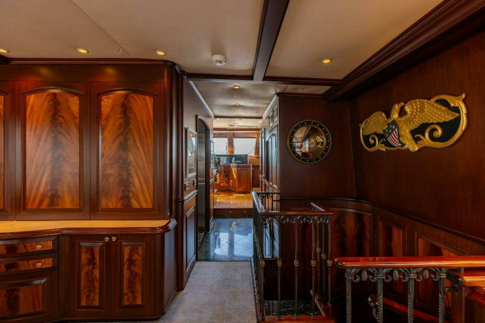 a room with wooden cabinets and a wood cabinet and a clock aboard STARLIGHT Yacht for Sale