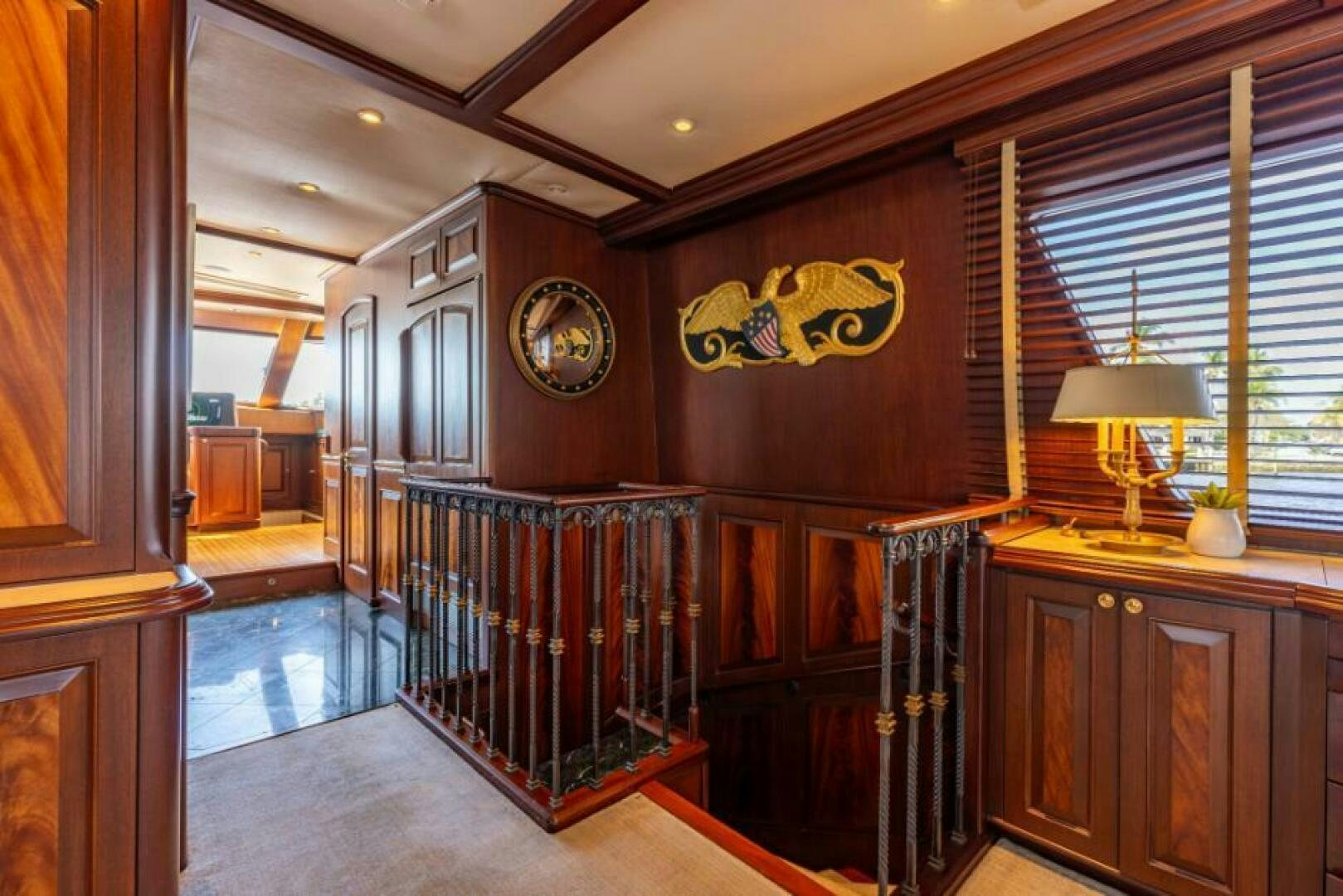 a room with a wood door and a chandelier aboard STARLIGHT Yacht for Sale
