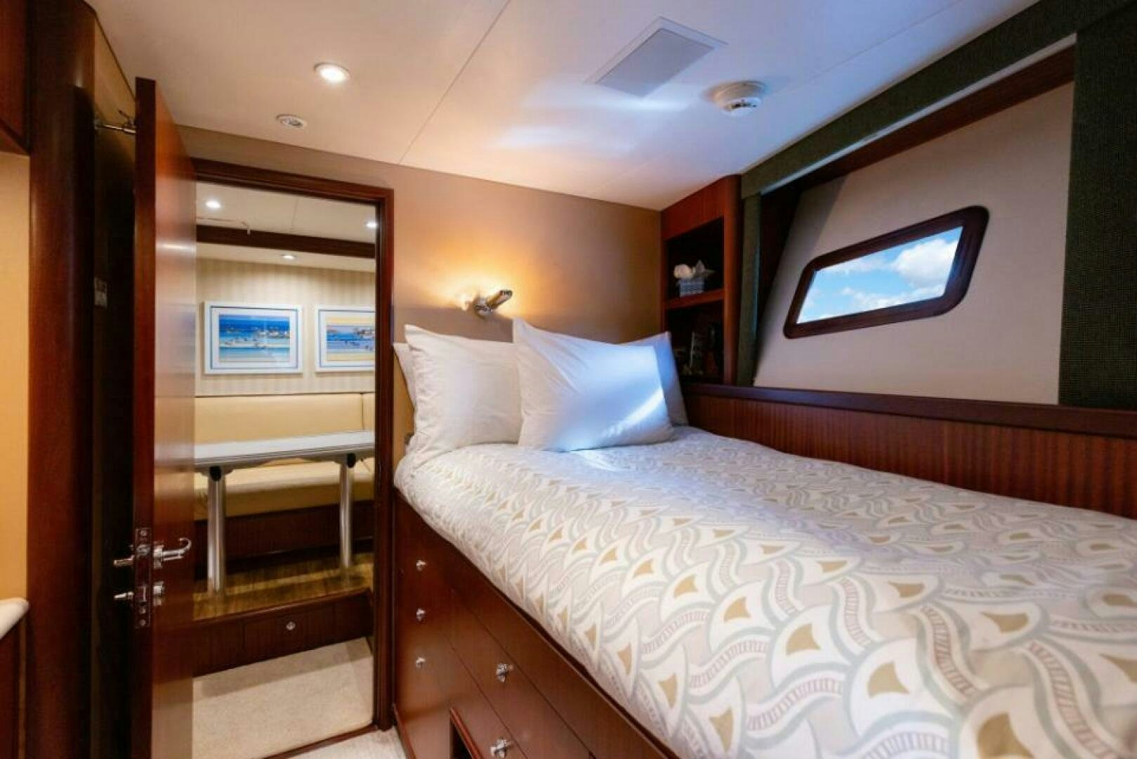 a bedroom with a bed and a tv on the wall aboard STARLIGHT Yacht for Sale