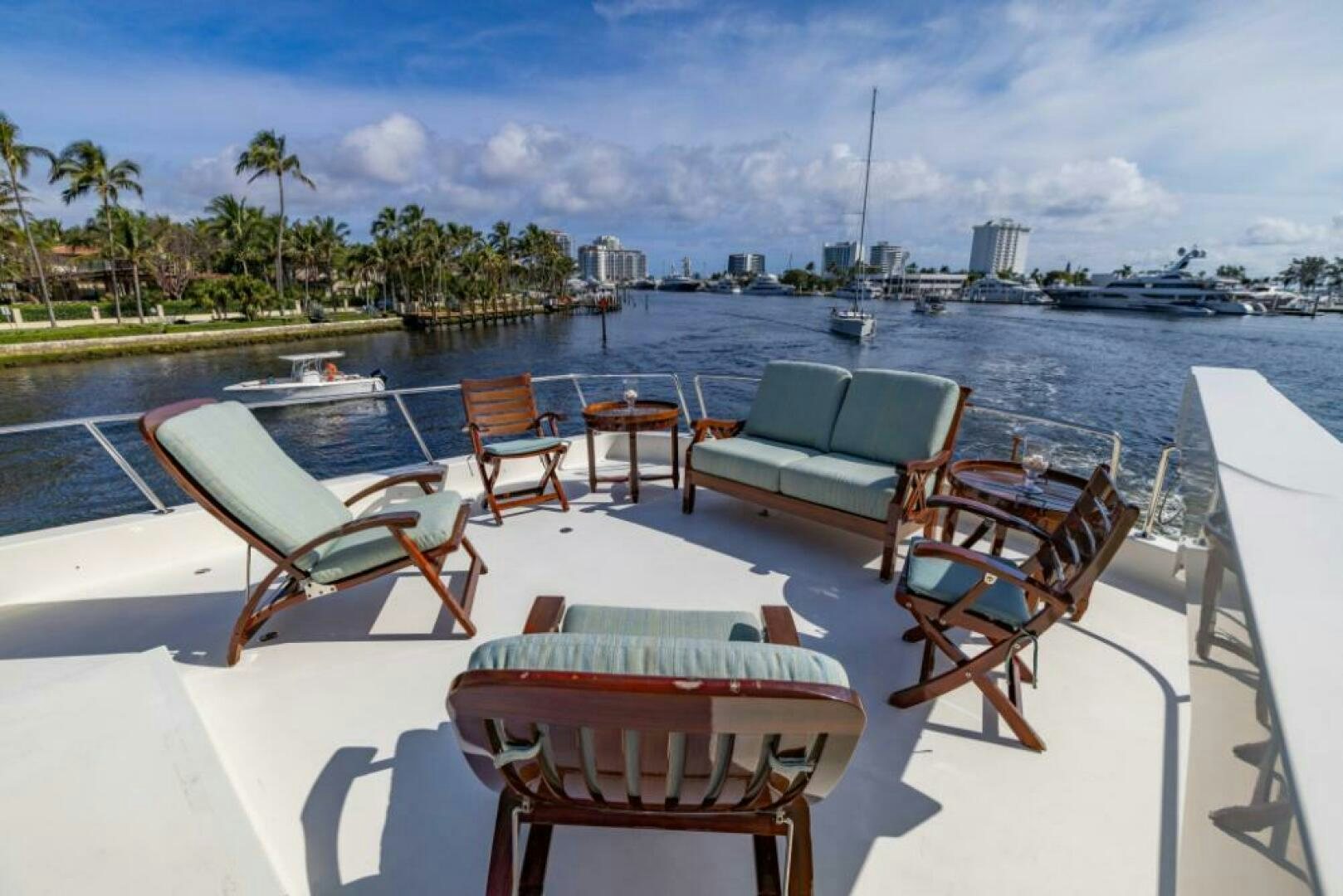 a pool with lounge chairs and a table on the side aboard STARLIGHT Yacht for Sale
