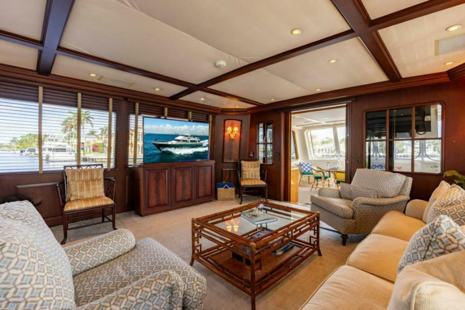 a living room with a large screen aboard STARLIGHT Yacht for Sale