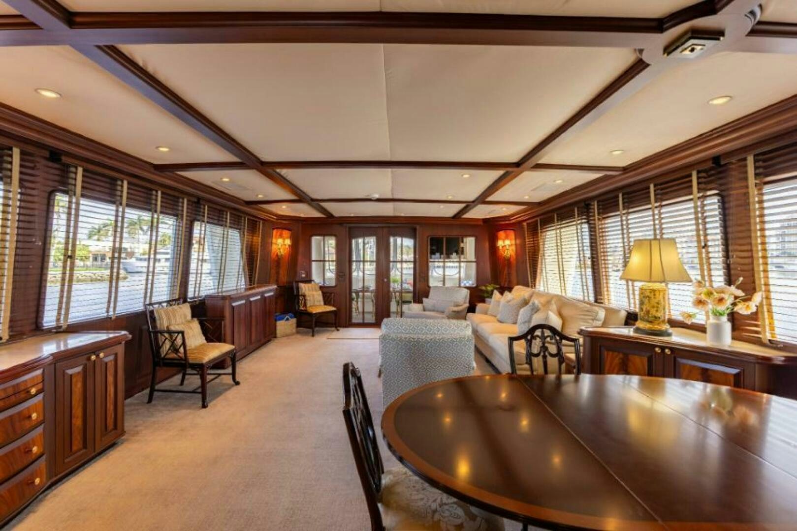 a large living room with a large table and chairs aboard STARLIGHT Yacht for Sale