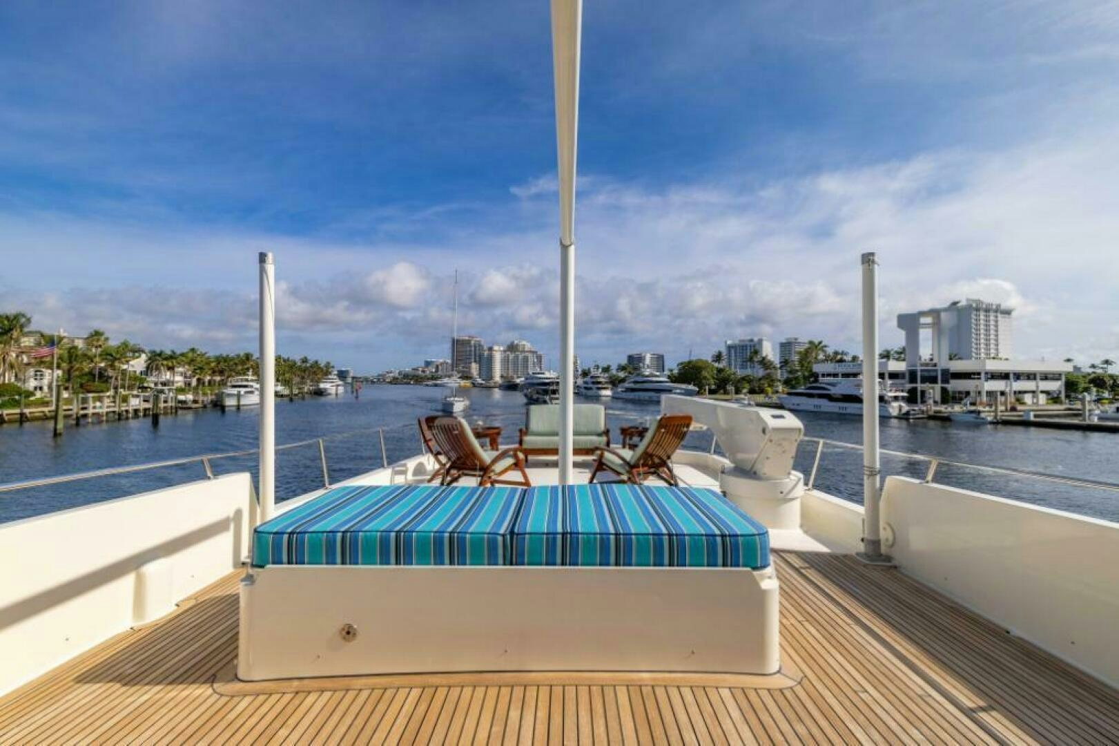 a deck with a chair and a table on it aboard STARLIGHT Yacht for Sale
