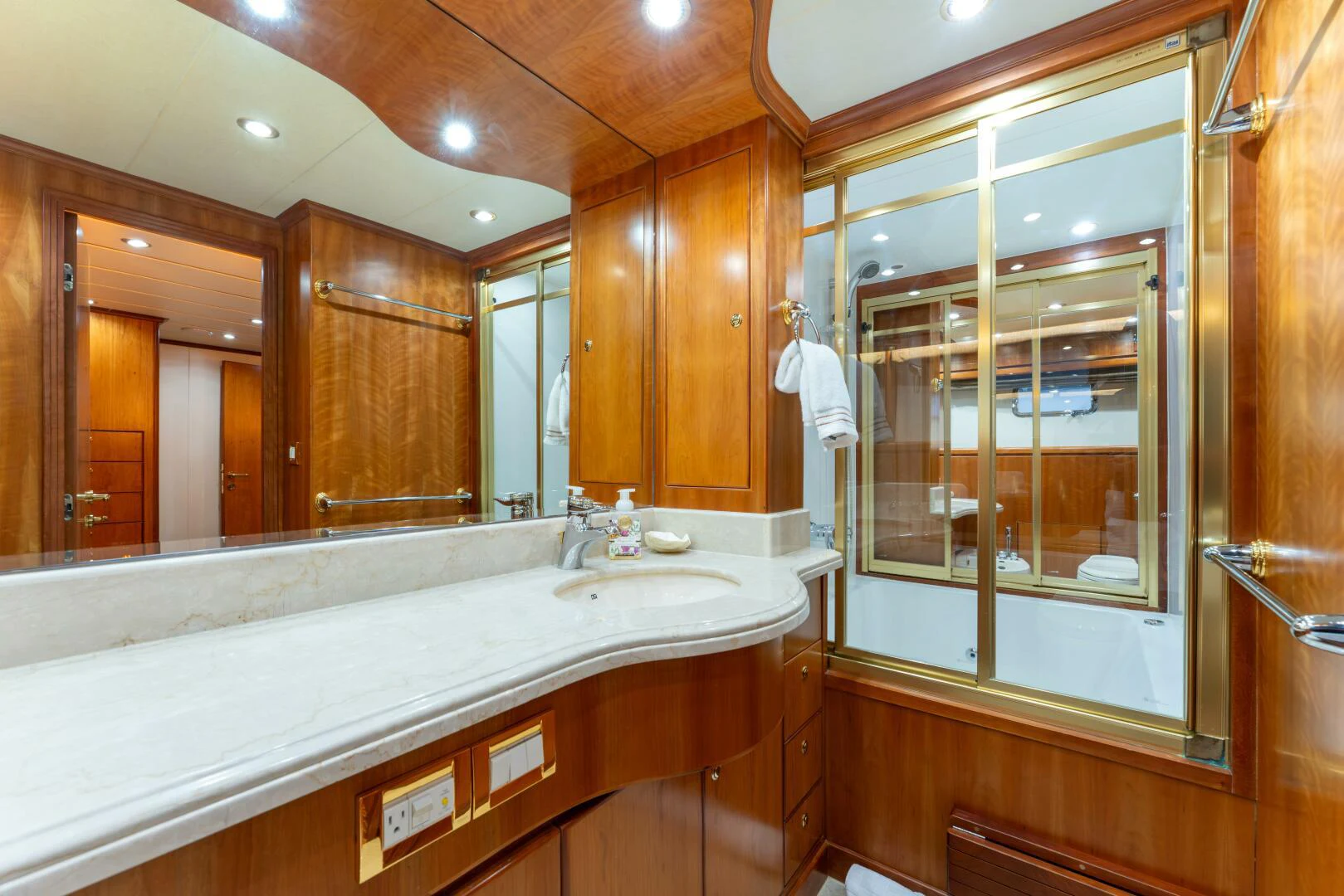 a bathroom with a large mirror aboard UN WINE Yacht for Sale