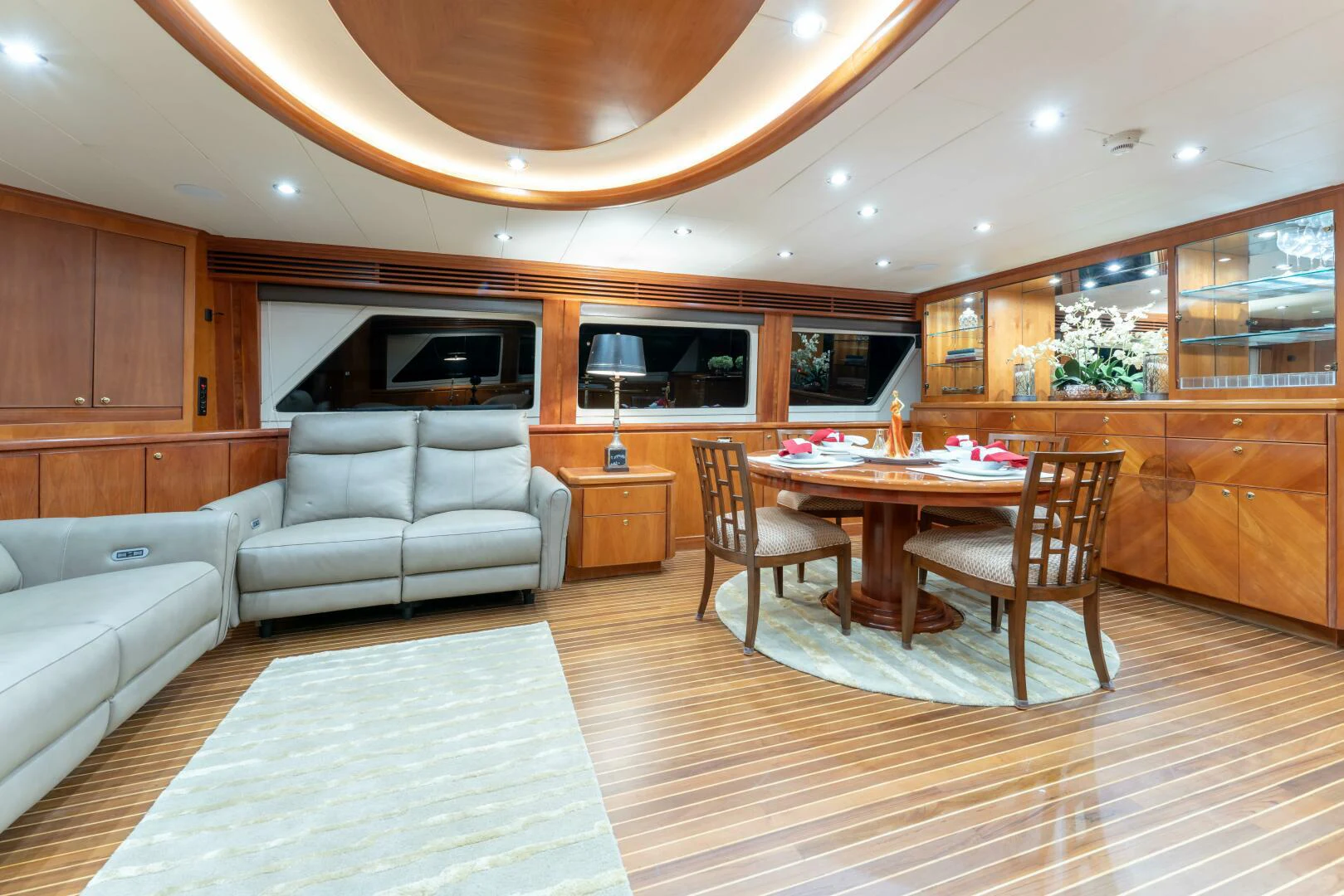 a living room with a table and couches aboard UN WINE Yacht for Sale