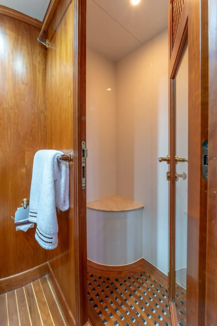 a bathroom with a wood door aboard UN WINE Yacht for Sale