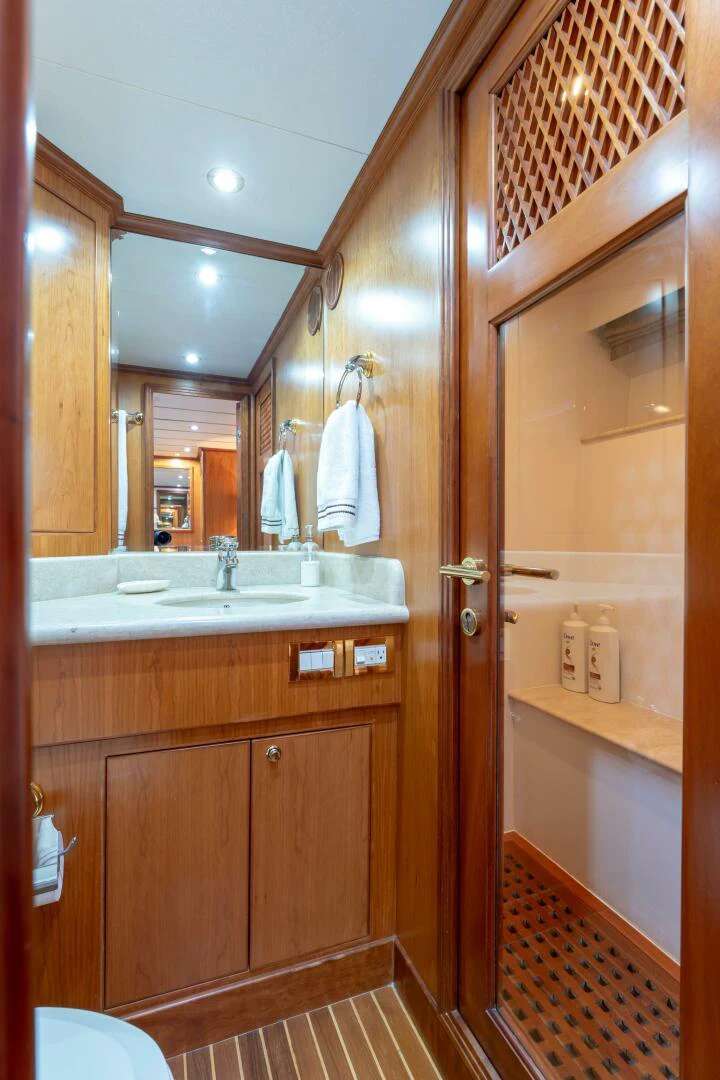 a bathroom with a sink and a mirror aboard UN WINE Yacht for Sale
