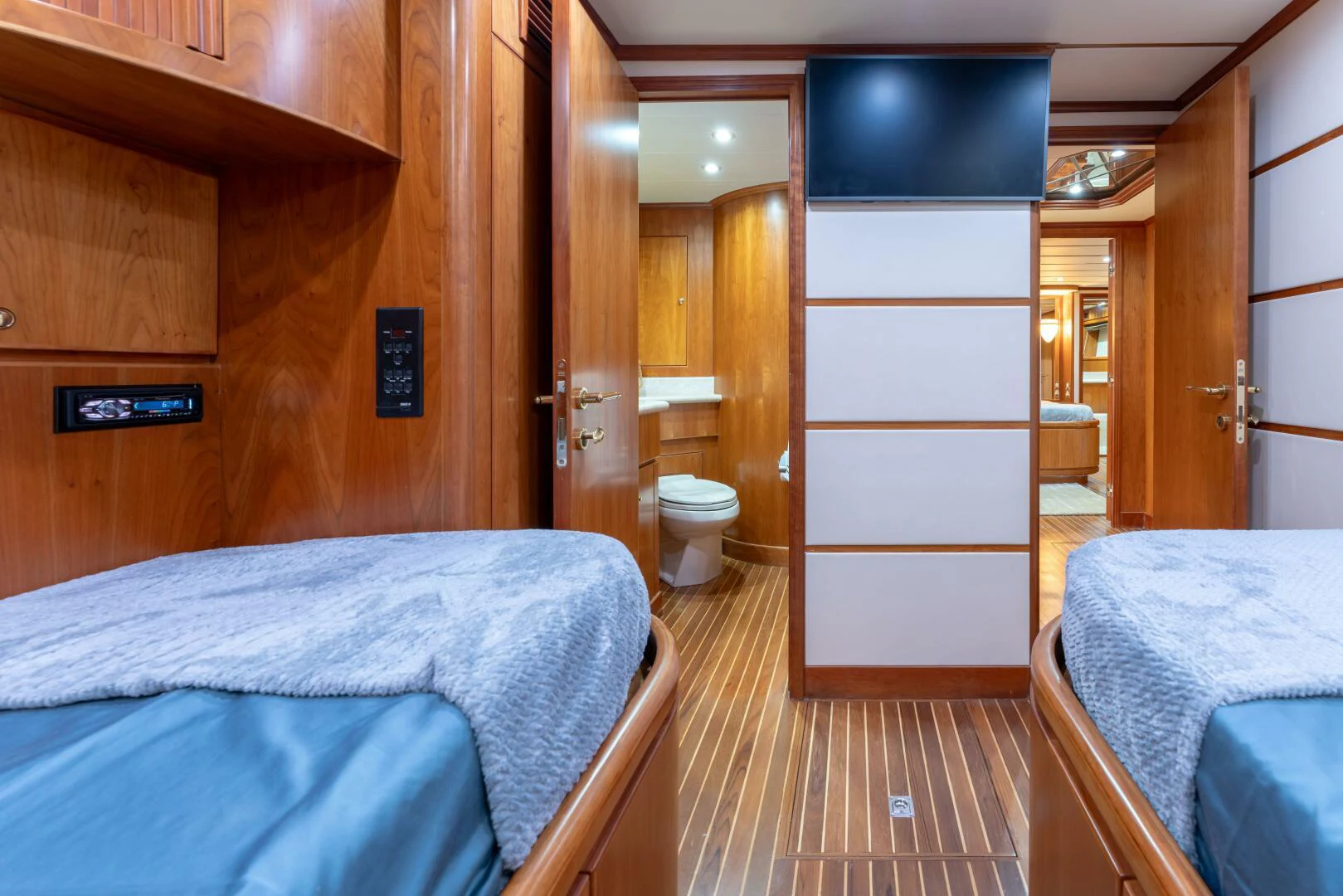 a bedroom with a bed and a closet aboard UN WINE Yacht for Sale
