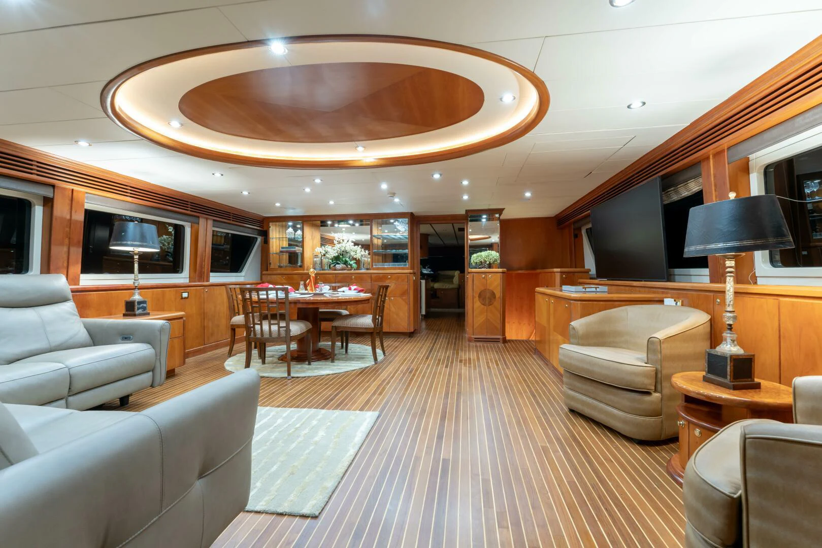 a living room with a large chandelier aboard UN WINE Yacht for Sale