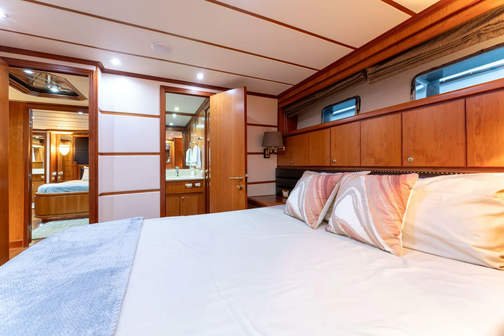 a bed with white sheets and pillows aboard UN WINE Yacht for Sale