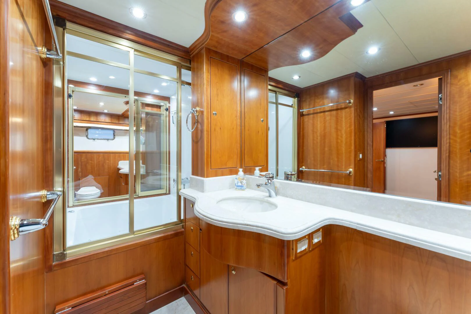 a bathroom with a large mirror aboard UN WINE Yacht for Sale