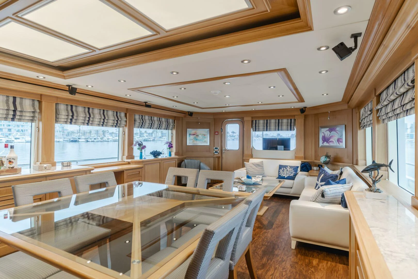 a large living room with a large table and chairs aboard UNDAUNTED Yacht for Sale