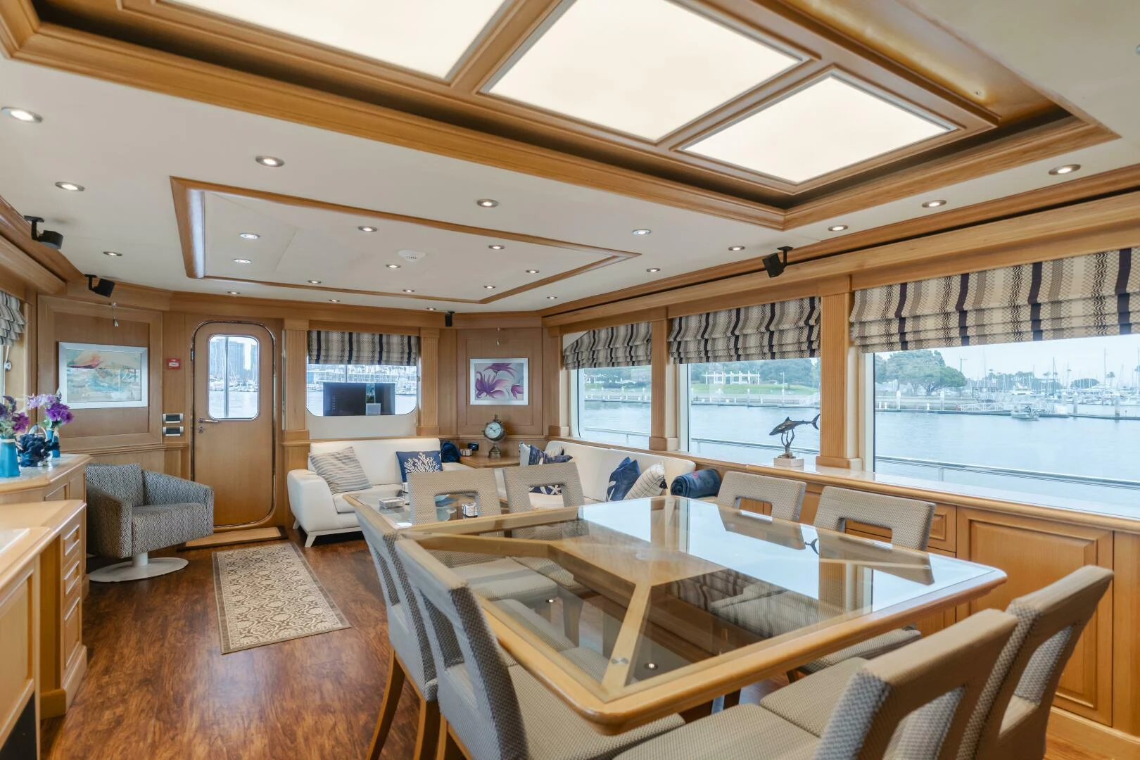 a large room with a table and chairs aboard UNDAUNTED Yacht for Sale