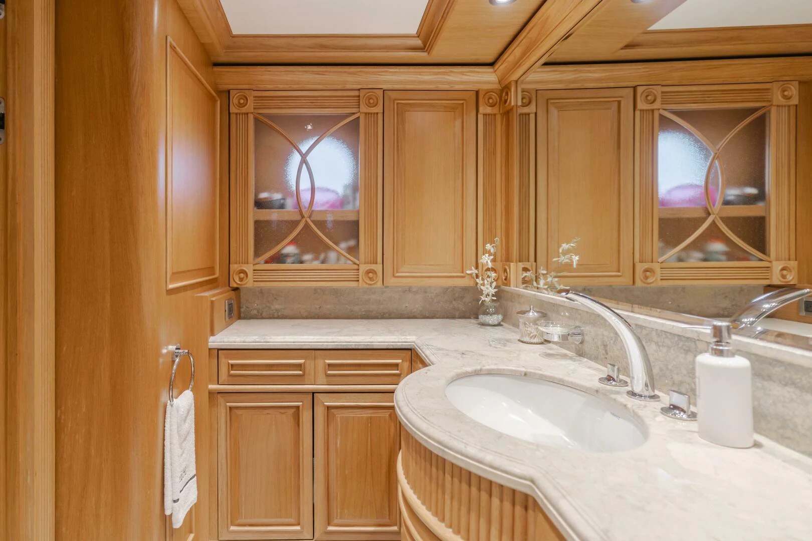 a bathroom with wooden cabinets aboard UNDAUNTED Yacht for Sale