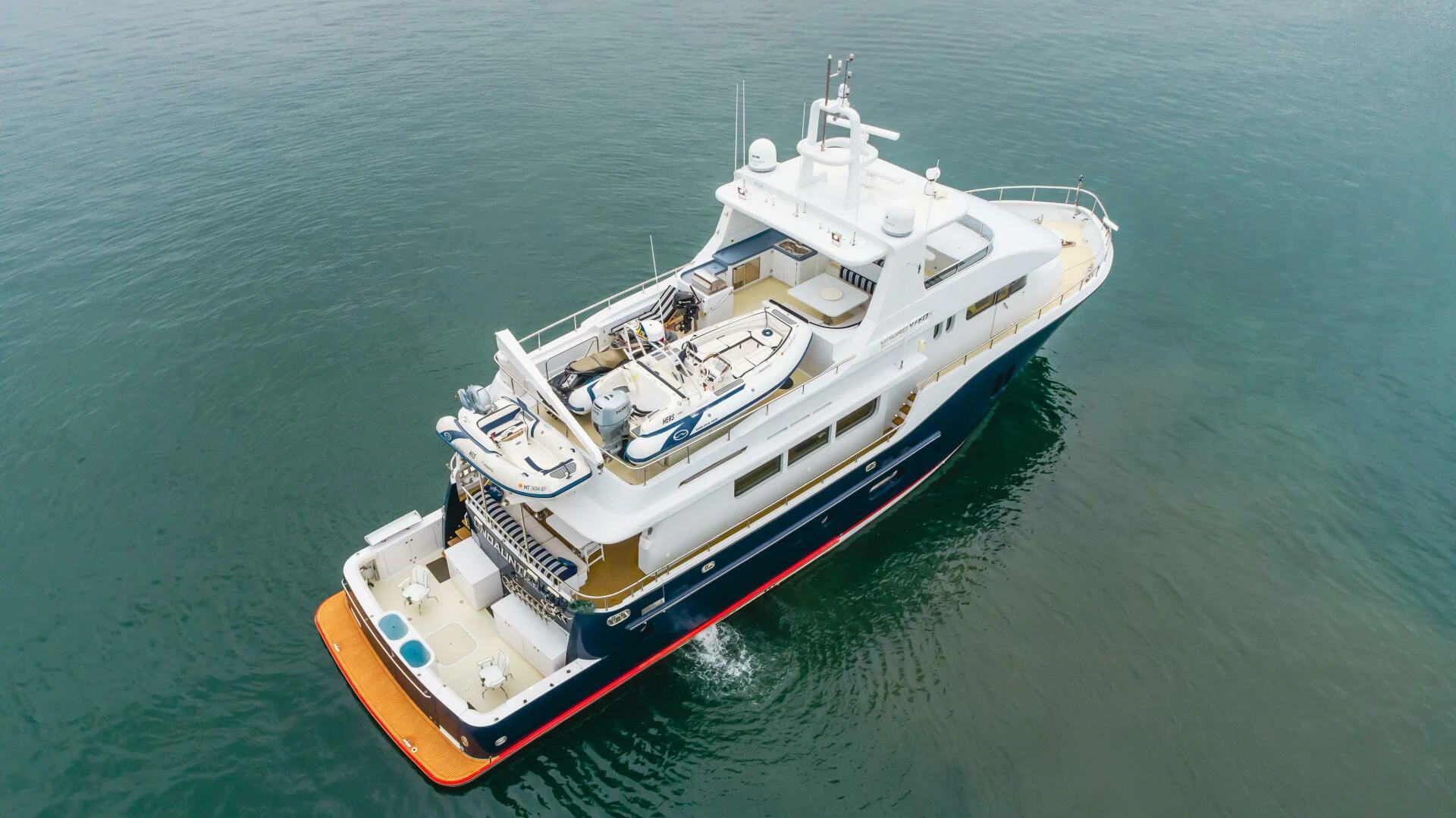 a large boat in the water aboard UNDAUNTED Yacht for Sale
