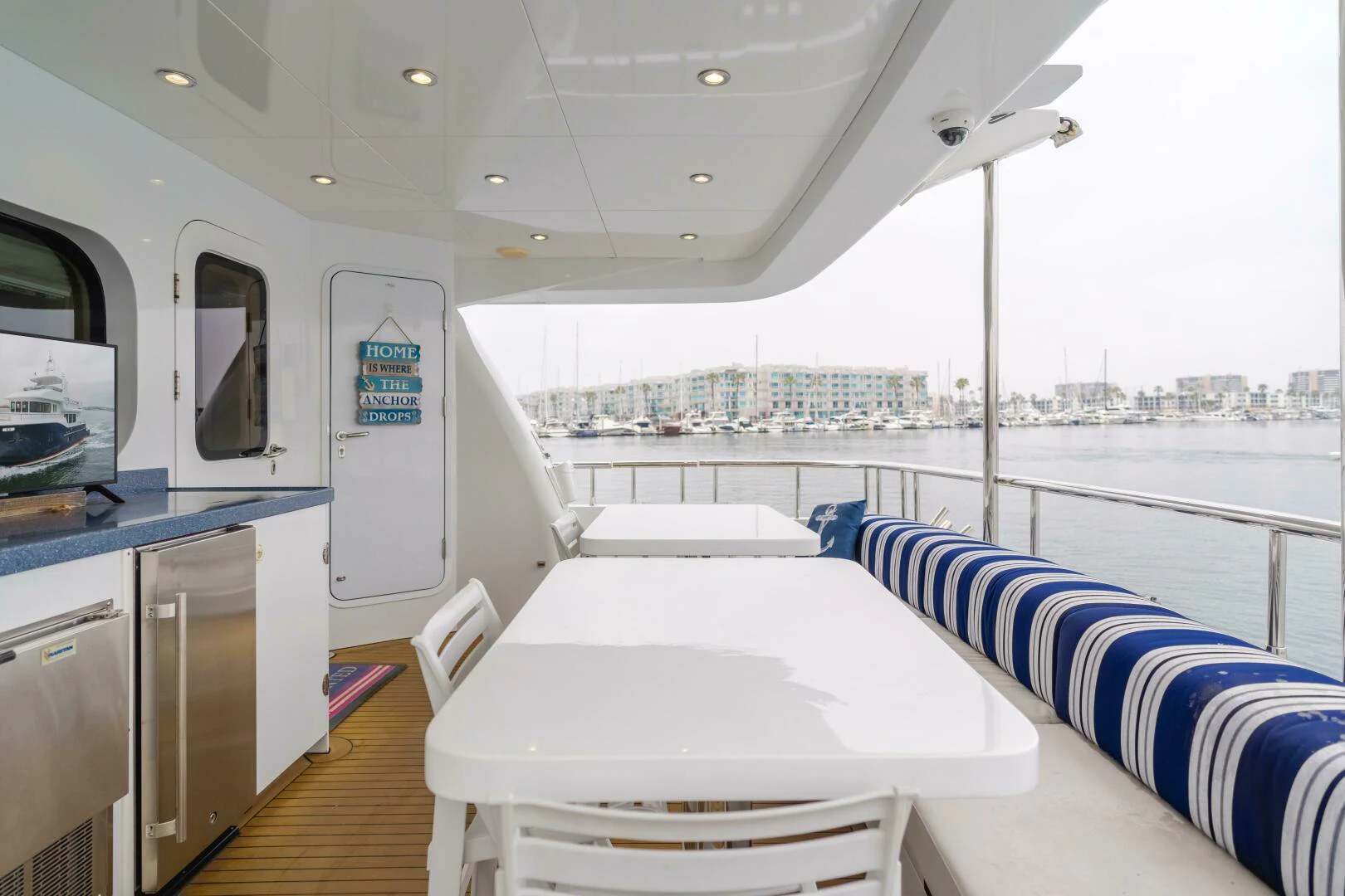a boat with a table and chairs aboard UNDAUNTED Yacht for Sale