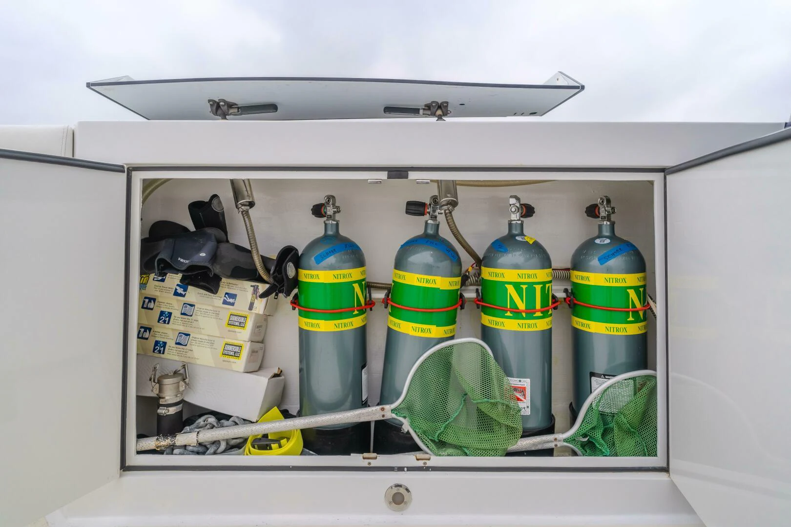 a refrigerator with a bunch of bottles inside aboard UNDAUNTED Yacht for Sale