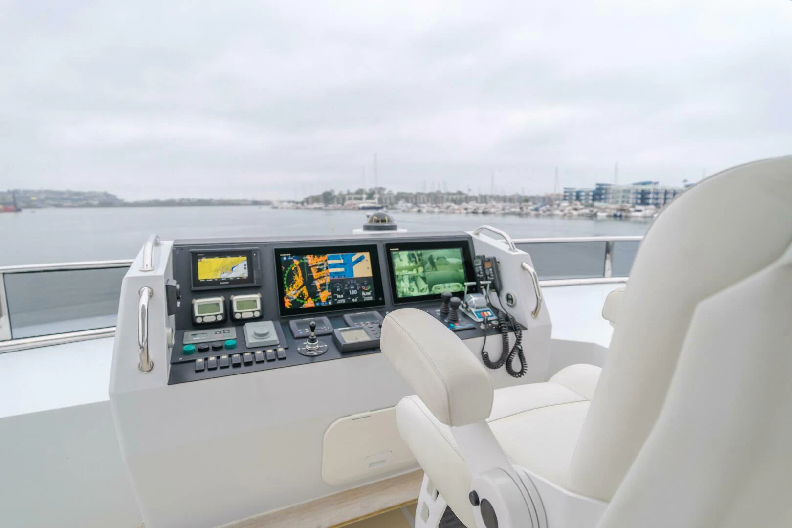a view of a boat with a computer screen and a view of the city below aboard UNDAUNTED Yacht for Sale