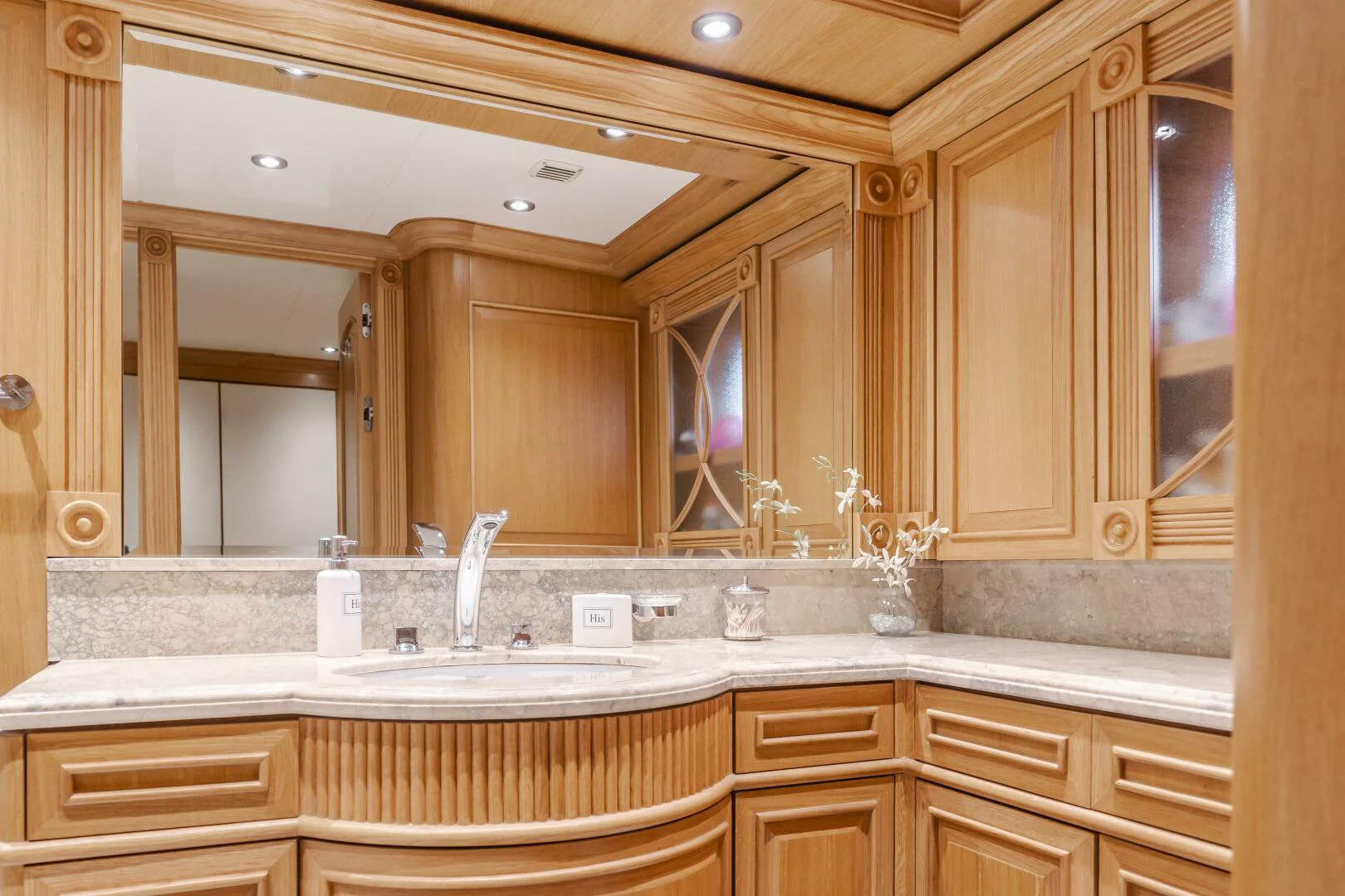 a bathroom with a large mirror aboard UNDAUNTED Yacht for Sale