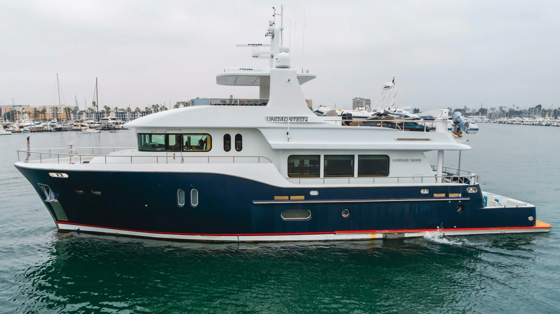 a large boat in the water aboard UNDAUNTED Yacht for Sale