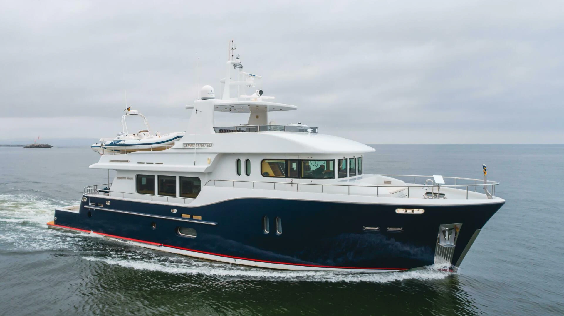 a boat on the water aboard UNDAUNTED Yacht for Sale