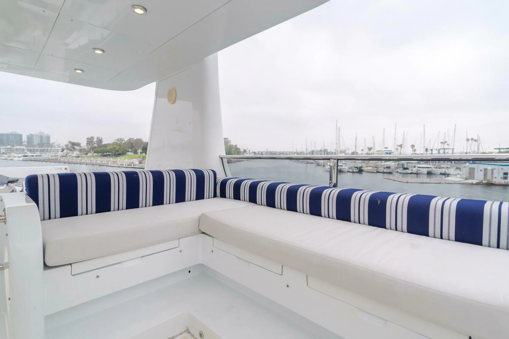 a row of white and blue striped seats on a boat aboard UNDAUNTED Yacht for Sale