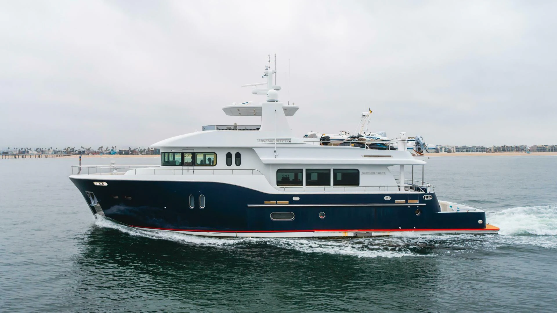 a large boat on the water aboard UNDAUNTED Yacht for Sale