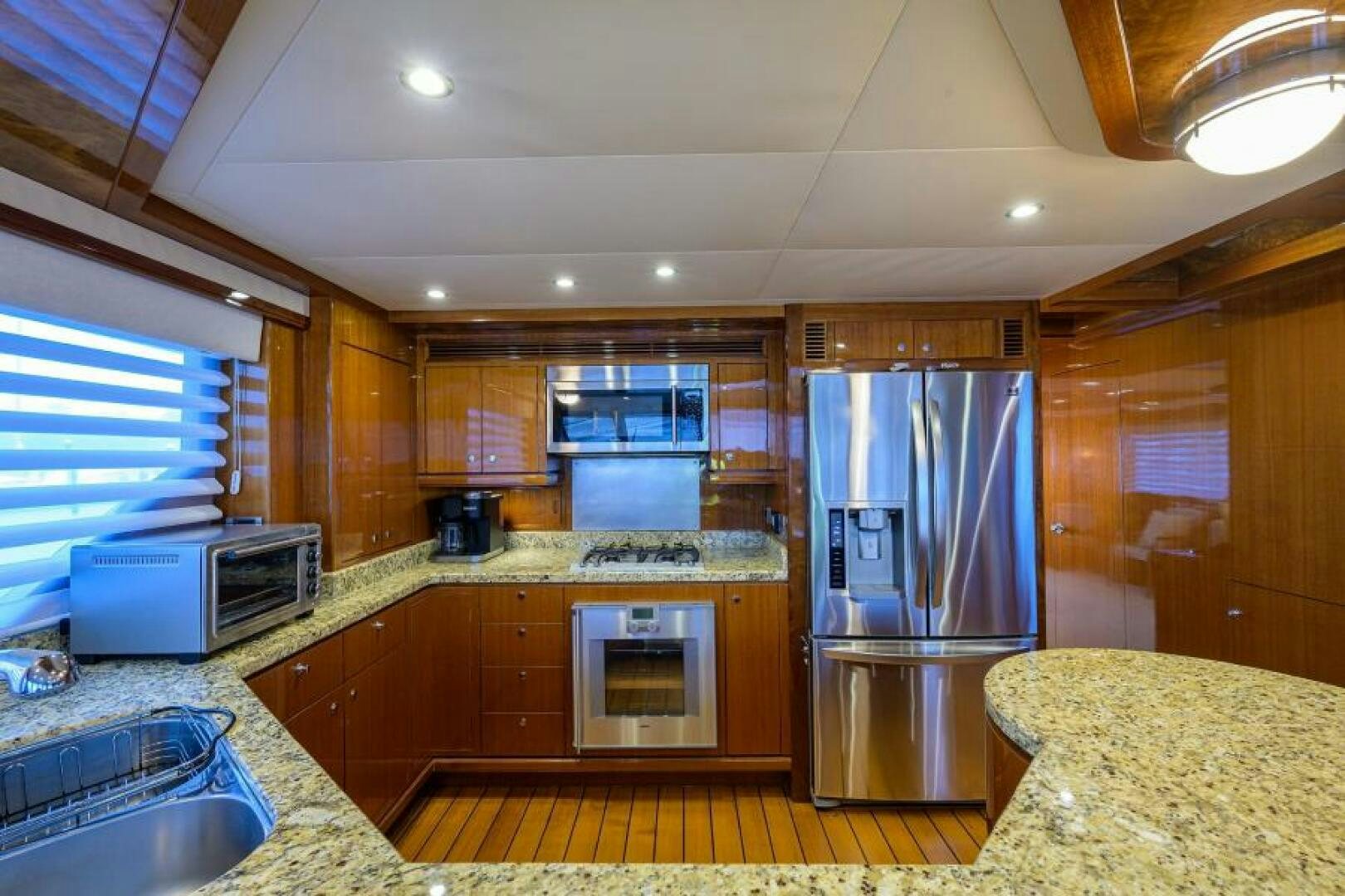 a kitchen with wooden cabinets aboard BARNSTAR Yacht for Sale