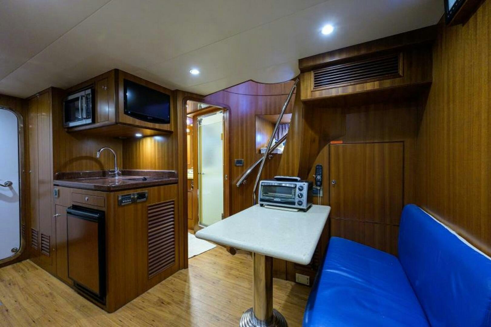 a kitchen with a table and a couch aboard BARNSTAR Yacht for Sale
