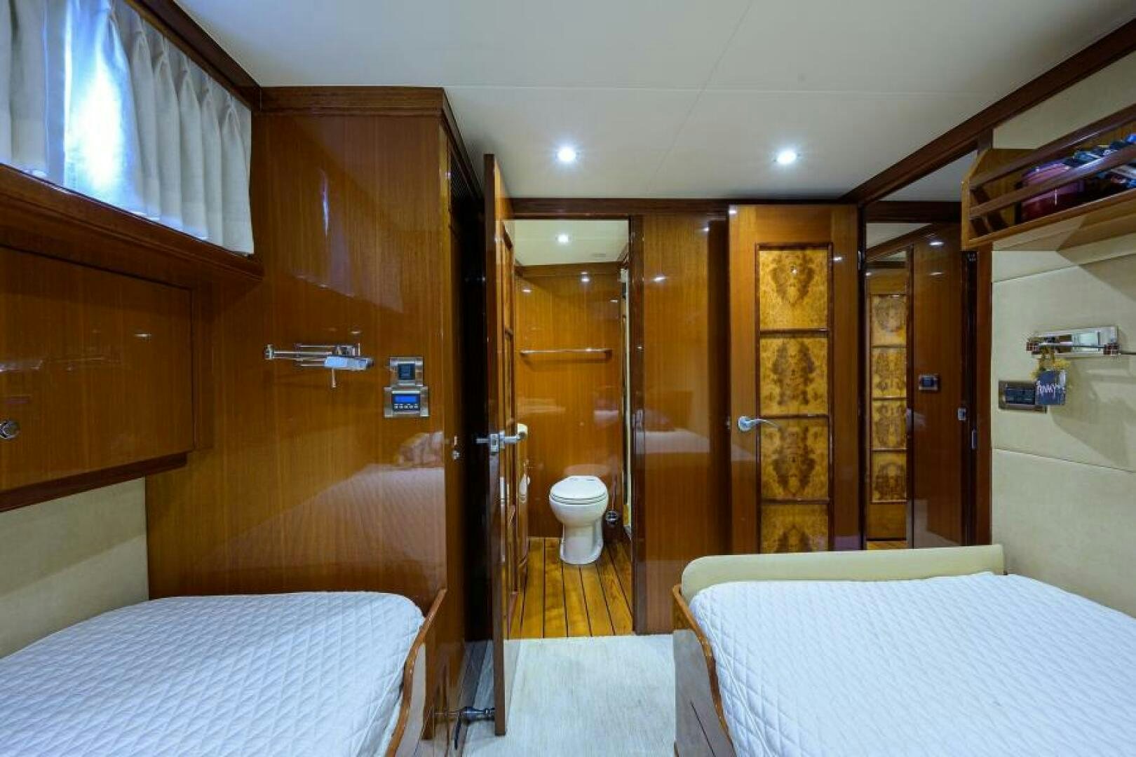 a room with a bed and a mirror aboard BARNSTAR Yacht for Sale