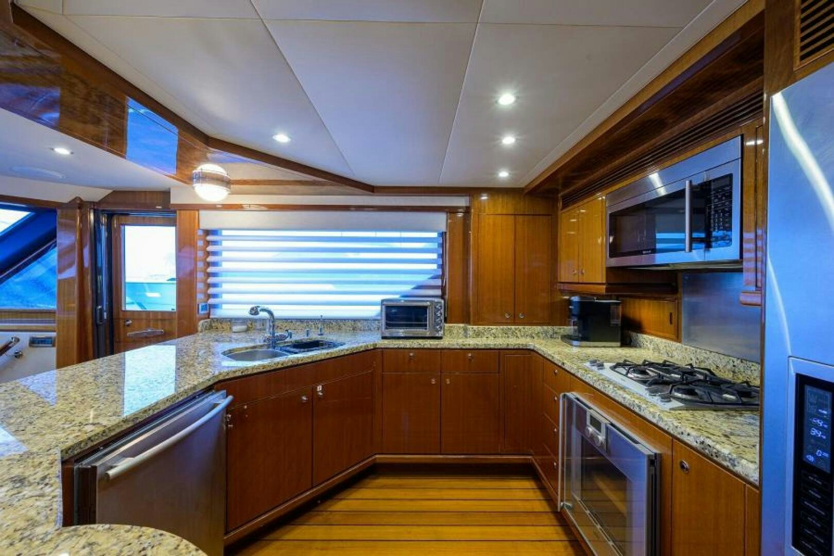 a kitchen with wooden cabinets aboard BARNSTAR Yacht for Sale