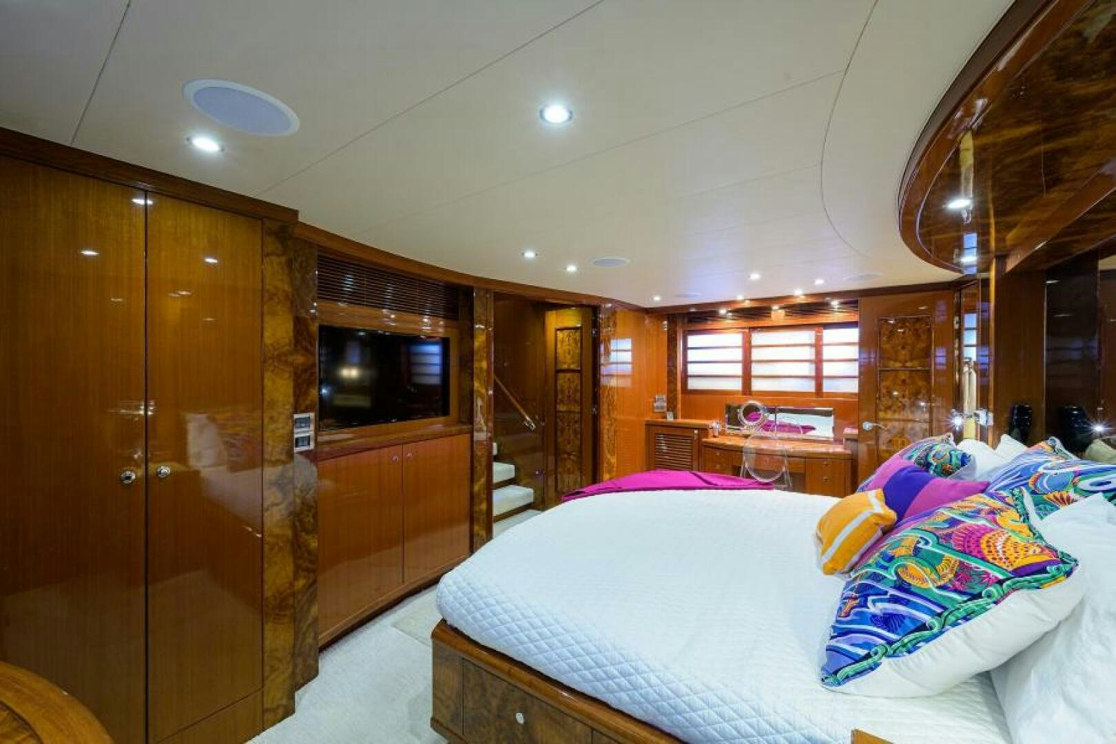 a bedroom with a bed and a tv on the wall aboard BARNSTAR Yacht for Sale